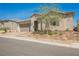Charming single-story home with stucco exterior, two-car garage, desert landscaping and a tile roof at 10126 Cliff Dwellings Ave, Las Vegas, NV 89178