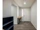 Close-up of the foyer with wood-look flooring, a decorative table, and a white front door at 10126 Cliff Dwellings Ave, Las Vegas, NV 89178