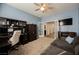 Stylish home office with gray sofa, ceiling fan, and workspace with modern decor at 10126 Cliff Dwellings Ave, Las Vegas, NV 89178