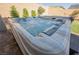 Inviting hot tub with bubbling water and comfortable seating, situated on a stone patio in a private backyard at 10126 Cliff Dwellings Ave, Las Vegas, NV 89178