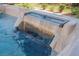A hot tub waterfall feature with crystal-clear water cascading down, creating a soothing and luxurious experience at 10126 Cliff Dwellings Ave, Las Vegas, NV 89178