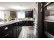 Modern kitchen with dark cabinets, stainless steel appliances, and light countertops at 10126 Cliff Dwellings Ave, Las Vegas, NV 89178
