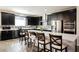 Modern kitchen with black cabinetry, stainless steel appliances, and a spacious center island with seating at 10126 Cliff Dwellings Ave, Las Vegas, NV 89178