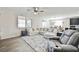 Spacious living room with a large sectional sofa and view of the backyard at 10126 Cliff Dwellings Ave, Las Vegas, NV 89178