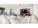 Cozy living room with a large sectional sofa, entertainment center, and wood-look flooring at 10126 Cliff Dwellings Ave, Las Vegas, NV 89178
