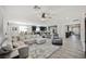 Spacious open-concept living room featuring a comfortable gray sectional sofa and modern decor at 10126 Cliff Dwellings Ave, Las Vegas, NV 89178
