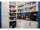 Well-organized pantry with white shelving, cabinets, and ample storage space at 10126 Cliff Dwellings Ave, Las Vegas, NV 89178