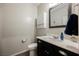 Chic powder room featuring a modern vanity with a dark cabinet and quartz countertop at 10126 Cliff Dwellings Ave, Las Vegas, NV 89178