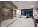 Sleek bathroom featuring a glass-enclosed shower, soaking tub, and modern fixtures at 12 Chisel Crest Ct, Henderson, NV 89012