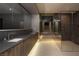 Modern bathroom with dual sinks, elegant vanity and a glass-enclosed shower creating a spa-like retreat at 12 Chisel Crest Ct, Henderson, NV 89012