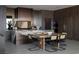 Chic dining area with a rustic wood table, modern seating, and stunning marble countertops at 12 Chisel Crest Ct, Henderson, NV 89012