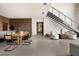 Contemporary dining room with stylish seating area adjacent to the staircase and sleek kitchen area at 12 Chisel Crest Ct, Henderson, NV 89012