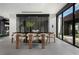 Modern dining room features a sleek table, stylish chairs, and a glass-enclosed wine storage area at 12 Chisel Crest Ct, Henderson, NV 89012