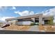 Contemporary home featuring xeriscaping, a red sports car and a modern exterior with stone accents at 12 Chisel Crest Ct, Henderson, NV 89012