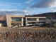 Contemporary home featuring clean lines, large windows, and a stone retaining wall at 12 Chisel Crest Ct, Henderson, NV 89012