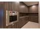 Modern kitchen with stainless steel Wolf oven and sleek wood cabinetry at 12 Chisel Crest Ct, Henderson, NV 89012