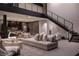 Open-concept living area boasts high ceilings, a modern staircase, and a comfortable seating area with large windows at 12 Chisel Crest Ct, Henderson, NV 89012