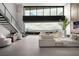 Open-concept living area features floor-to-ceiling windows and sleek staircase to capture city views at 12 Chisel Crest Ct, Henderson, NV 89012