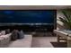 This room features a modern couch, sleek tile flooring, and a large window that offers views of the city skyline at 12 Chisel Crest Ct, Henderson, NV 89012