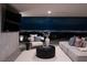 Comfortable living room features cozy seating, a modern TV, and expansive views of the city skyline at night at 12 Chisel Crest Ct, Henderson, NV 89012