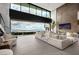 Spacious living room showcases large glass doors, seamless indoor-outdoor living, and cozy, modern furnishings at 12 Chisel Crest Ct, Henderson, NV 89012
