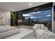 Luxurious main bedroom featuring a seating area and an expansive sliding glass doors with a stunning view at 12 Chisel Crest Ct, Henderson, NV 89012