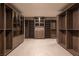 Spacious walk-in closet with custom wood shelving and drawers for organized storage at 12 Chisel Crest Ct, Henderson, NV 89012