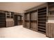 Extensive walk-in closet with ample wood shelving and drawer units for optimal storage at 12 Chisel Crest Ct, Henderson, NV 89012
