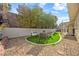 Artificial grass area surrounded by decorative rock creating a low-maintenance backyard at 1619 Abby Ave, Henderson, NV 89014