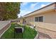 Cozy backyard seating area with artificial grass and low-maintenance landscaping at 1619 Abby Ave, Henderson, NV 89014