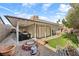Fully landscaped backyard with artificial grass, fire pit, and covered patio at 1619 Abby Ave, Henderson, NV 89014
