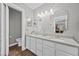 Elegant bathroom with double sinks, large mirrors, and white cabinetry at 1619 Abby Ave, Henderson, NV 89014
