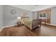Comfortable bedroom with a queen-size bed, large window, and wood floors at 1619 Abby Ave, Henderson, NV 89014