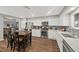 Bright kitchen featuring stainless steel appliances, white cabinets and a gray backsplash at 1619 Abby Ave, Henderson, NV 89014