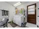 Functional laundry room equipped with a washer, dryer, and storage shelves at 1619 Abby Ave, Henderson, NV 89014