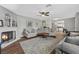 Cozy living room featuring a white brick fireplace, hardwood floors and comfortable gray sofas at 1619 Abby Ave, Henderson, NV 89014