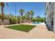 Backyard with desert landscaping, a lawn, pool, and access to the home at 2209 Purple Majesty Ct, Las Vegas, NV 89117