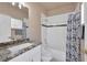 Bathroom featuring granite counters, patterned shower curtain and a tub at 2209 Purple Majesty Ct, Las Vegas, NV 89117