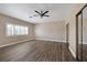 This sizable bedroom offers ample natural light, mirrored closets, and wood-look floors at 2209 Purple Majesty Ct, Las Vegas, NV 89117