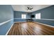 Large bedroom provides ample natural light through shuttered windows, complimented by wood-look floors at 2209 Purple Majesty Ct, Las Vegas, NV 89117