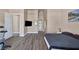 This bedroom boasts wood-look floors, a TV, and an open layout at 2209 Purple Majesty Ct, Las Vegas, NV 89117