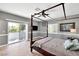 Primary bedroom with a four poster bed, wood floors and access to a private balcony at 2209 Purple Majesty Ct, Las Vegas, NV 89117