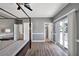 Primary bedroom with a four poster bed, wood floors, private balcony and ensuite bath at 2209 Purple Majesty Ct, Las Vegas, NV 89117