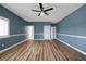 This spacious bedroom provides wood-look flooring, ceiling fan, and bright neutral paint at 2209 Purple Majesty Ct, Las Vegas, NV 89117