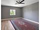 Bedroom with wood floors, ceiling fan, neutral walls and a patterned rug at 2209 Purple Majesty Ct, Las Vegas, NV 89117