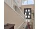 View of the home's foyer featuring marble floors, a double door entry and a staircase at 2209 Purple Majesty Ct, Las Vegas, NV 89117