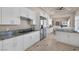 Open kitchen with white cabinets, stainless steel appliances, and eat-in area at 2209 Purple Majesty Ct, Las Vegas, NV 89117