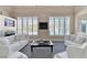 This bright living room features a fireplace, neutral tones, and plantation shutters at 2209 Purple Majesty Ct, Las Vegas, NV 89117