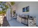 Outdoor kitchen features a built-in barbecue, sink, storage, and countertop space at 2209 Purple Majesty Ct, Las Vegas, NV 89117