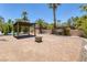 Expansive brick patio featuring a covered pergola and a charming fire pit perfect for outdoor entertaining at 2209 Purple Majesty Ct, Las Vegas, NV 89117